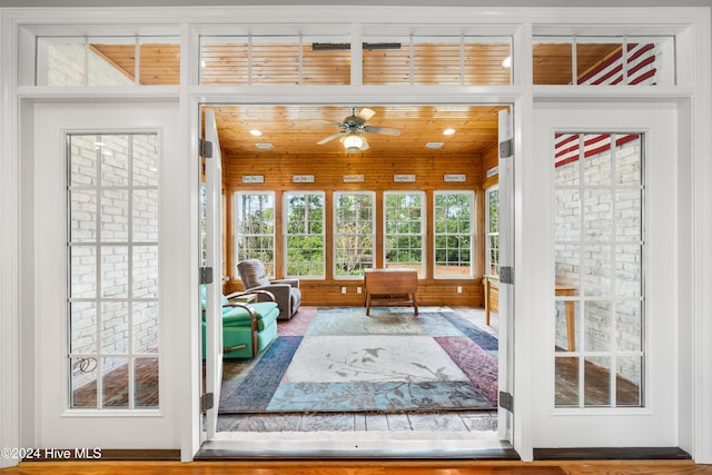 interior space featuring hardwood / wood-style flooring, ceiling fan, and wood ceiling