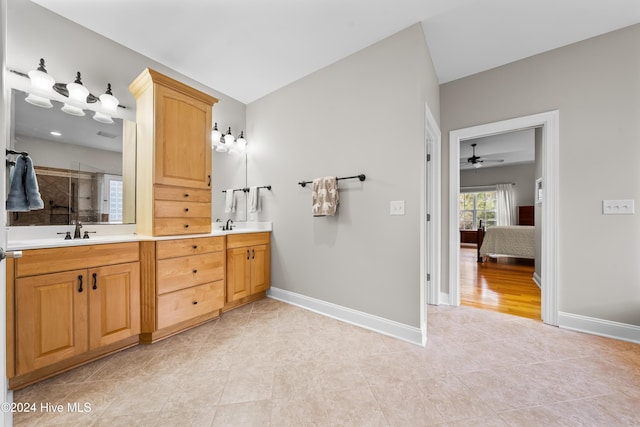 bathroom with tile patterned floors, ceiling fan, vanity, and walk in shower