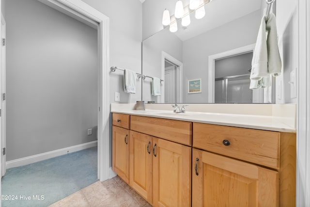 bathroom with vanity and a shower with door