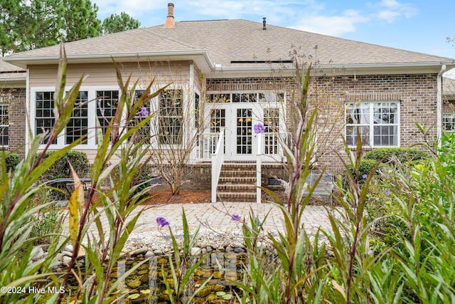 back of property featuring french doors