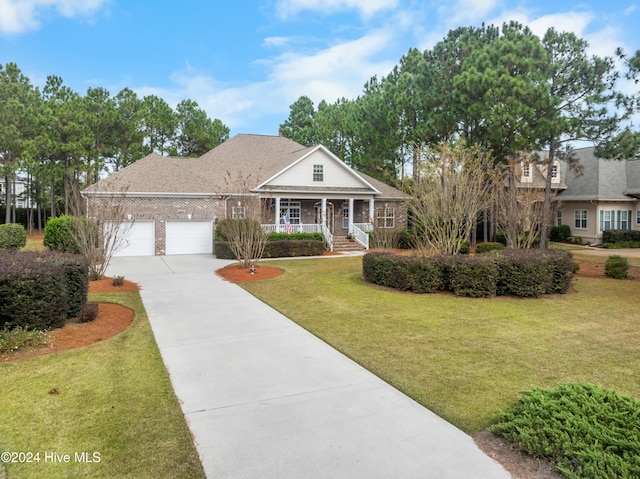 view of front facade featuring a porch, a garage, and a front lawn