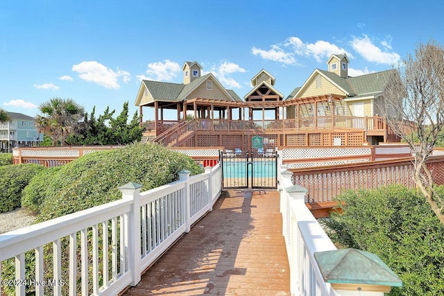 rear view of house featuring a fenced in pool