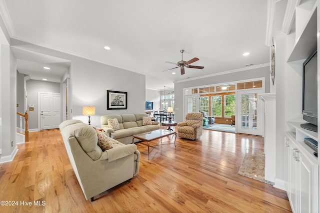 living room featuring ceiling fan, light hardwood / wood-style floors, and ornamental molding