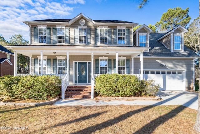 view of front of home with a garage, covered porch, and a front yard