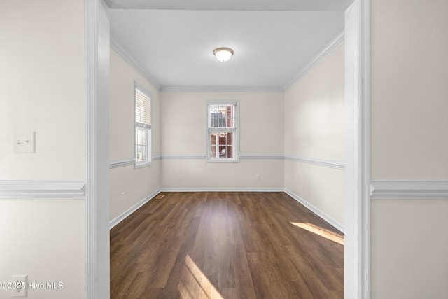 empty room featuring dark hardwood / wood-style floors and crown molding