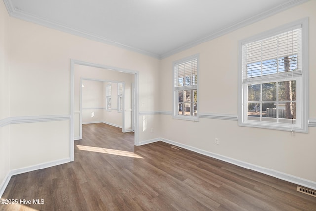 spare room with ornamental molding and dark wood-type flooring