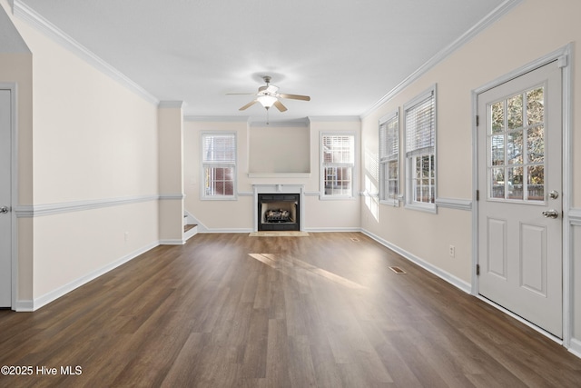 unfurnished living room featuring dark hardwood / wood-style flooring, ceiling fan, and ornamental molding