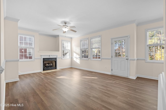 unfurnished living room with crown molding, dark hardwood / wood-style flooring, and ceiling fan