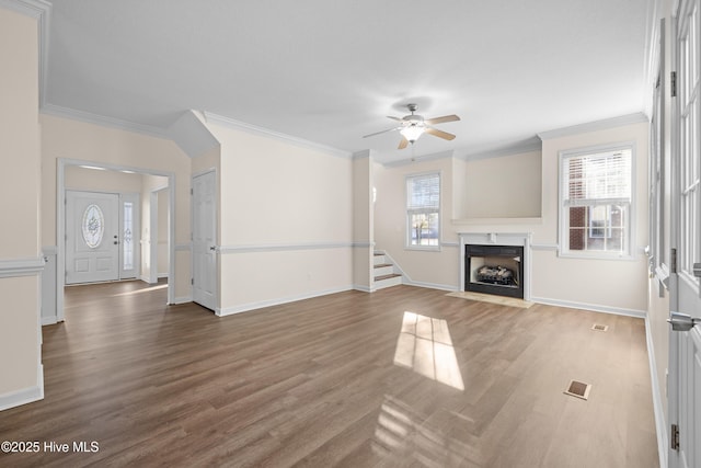 unfurnished living room featuring hardwood / wood-style floors, a healthy amount of sunlight, and ornamental molding