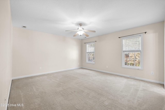 unfurnished room with ceiling fan and light colored carpet