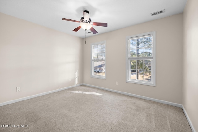 carpeted empty room featuring ceiling fan