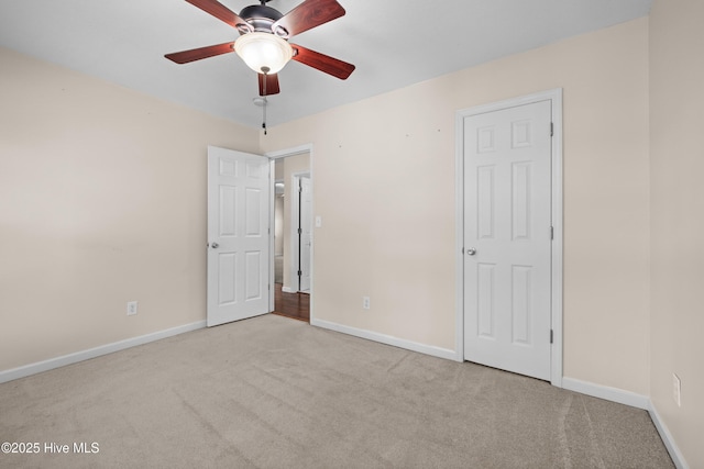 unfurnished bedroom with ceiling fan and light carpet