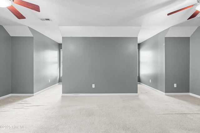 spare room featuring ceiling fan and light carpet