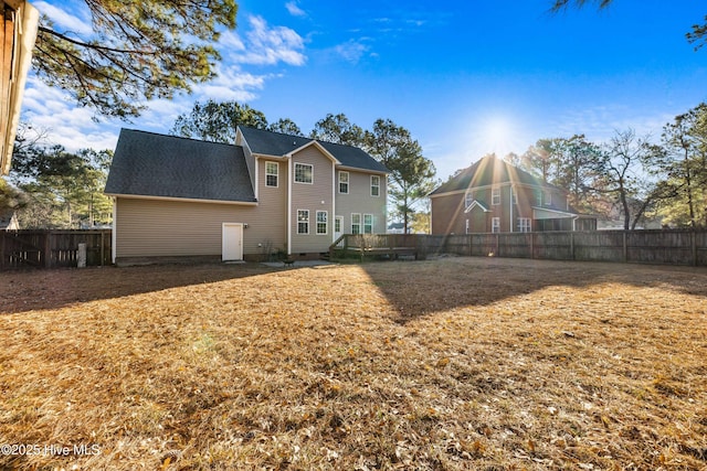 back of house featuring a lawn