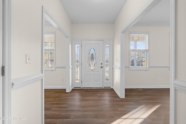 foyer entrance featuring dark hardwood / wood-style floors and ornamental molding