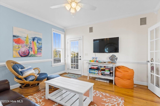 living room featuring ceiling fan, hardwood / wood-style floors, and ornamental molding