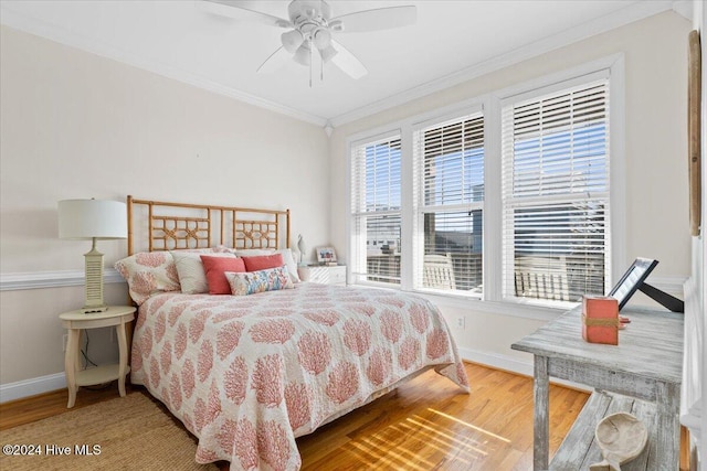 bedroom featuring wood-type flooring, ceiling fan, and crown molding