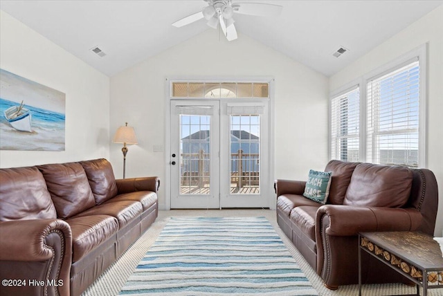 living room featuring ceiling fan, light colored carpet, and lofted ceiling