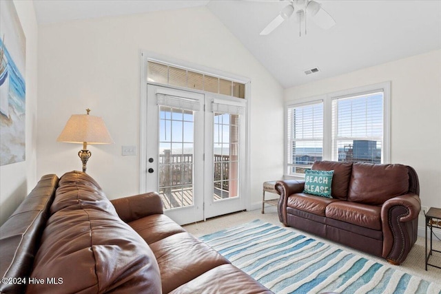 living room featuring ceiling fan, light colored carpet, and vaulted ceiling