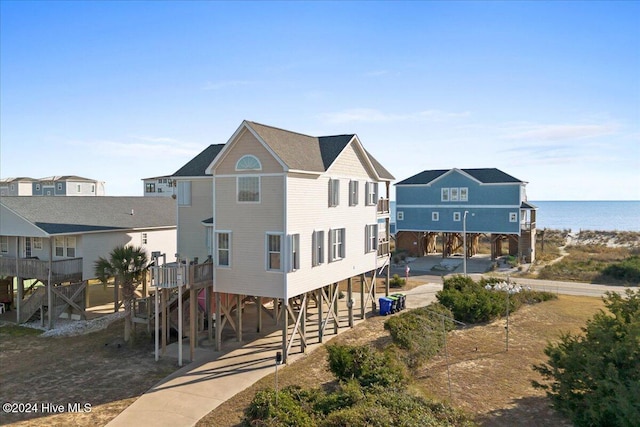 back of property featuring a water view and a carport