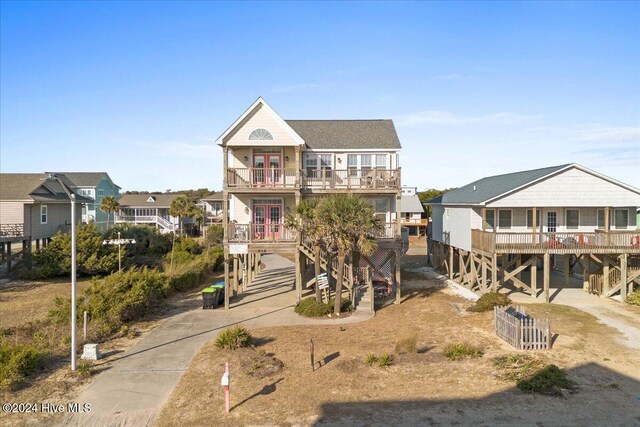 coastal inspired home with a carport and a balcony