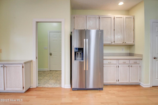 kitchen with light hardwood / wood-style floors and stainless steel refrigerator with ice dispenser