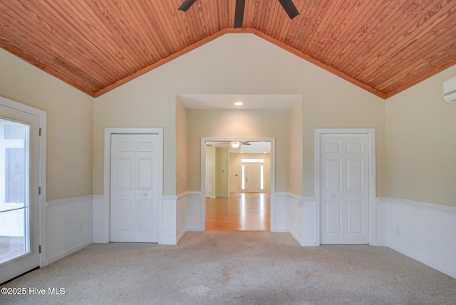 spare room with ceiling fan, light colored carpet, wood ceiling, and vaulted ceiling