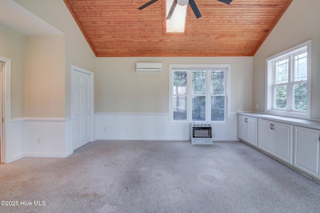 unfurnished room with a wall mounted air conditioner, light colored carpet, lofted ceiling, and wood ceiling