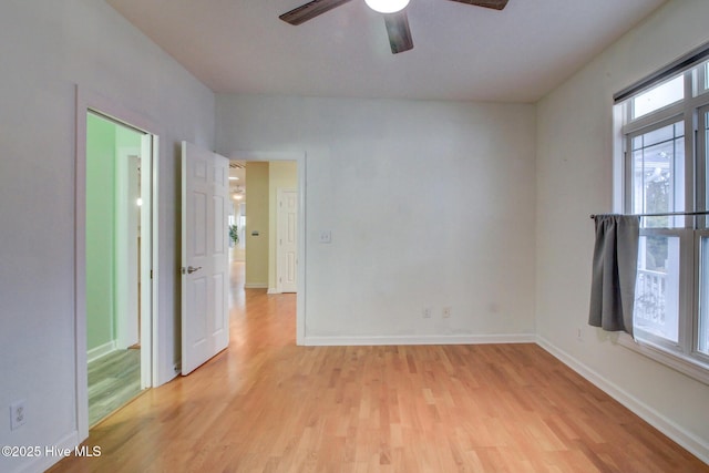 unfurnished room featuring light hardwood / wood-style floors and ceiling fan