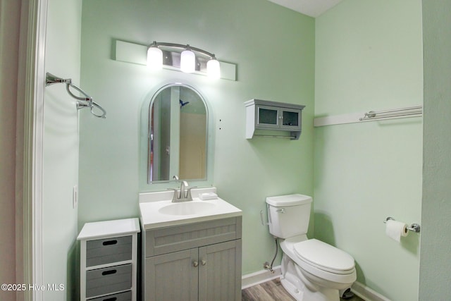 bathroom with hardwood / wood-style floors, vanity, and toilet