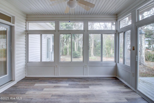 unfurnished sunroom with ceiling fan and a healthy amount of sunlight