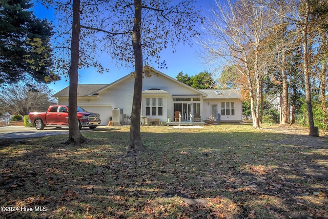 exterior space featuring a garage and a front lawn