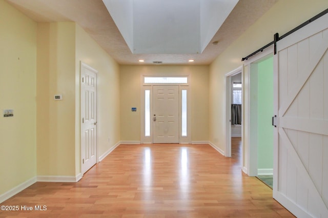 entrance foyer featuring a barn door and light hardwood / wood-style flooring