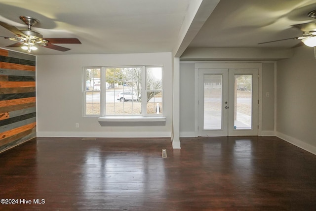 unfurnished living room with french doors, dark hardwood / wood-style floors, and ceiling fan