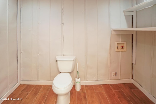 bathroom featuring hardwood / wood-style flooring and toilet