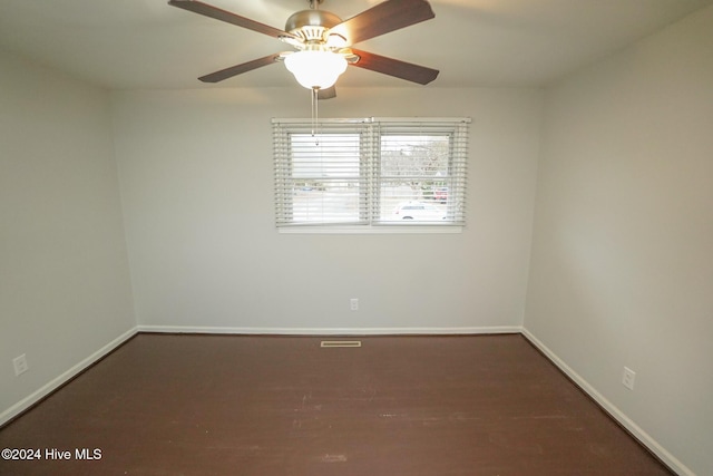 empty room with ceiling fan and dark wood-type flooring