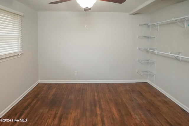 unfurnished bedroom with dark hardwood / wood-style flooring, a closet, and ceiling fan