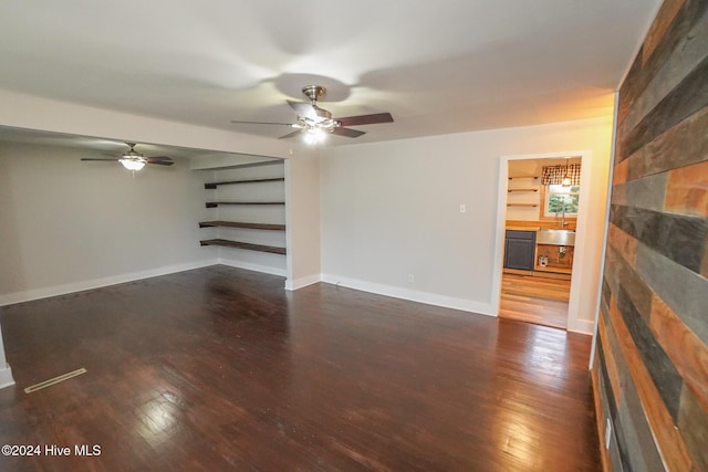 unfurnished living room with sink and dark hardwood / wood-style floors