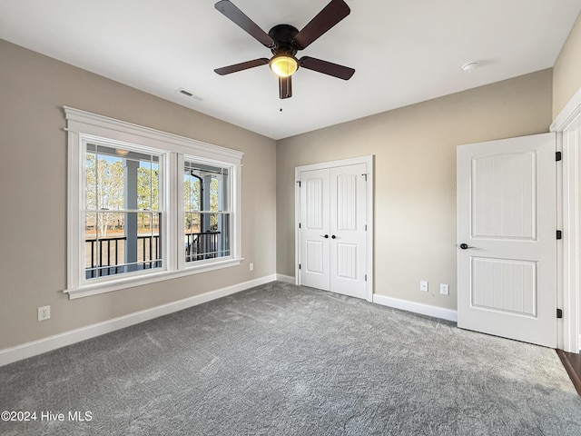 unfurnished bedroom featuring carpet flooring, ceiling fan, and a closet