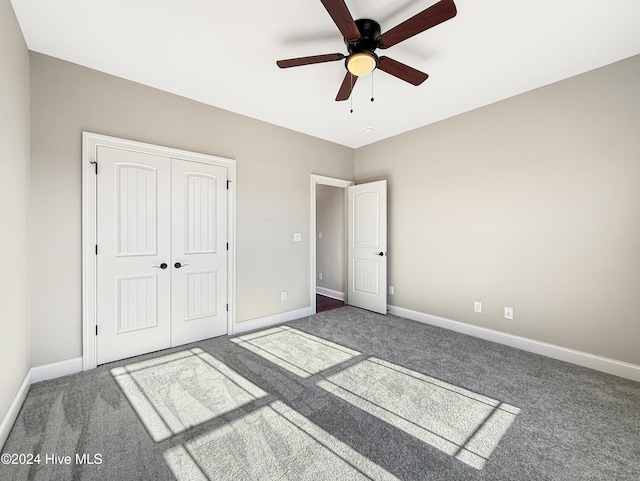 unfurnished bedroom with carpet flooring, ceiling fan, and a closet