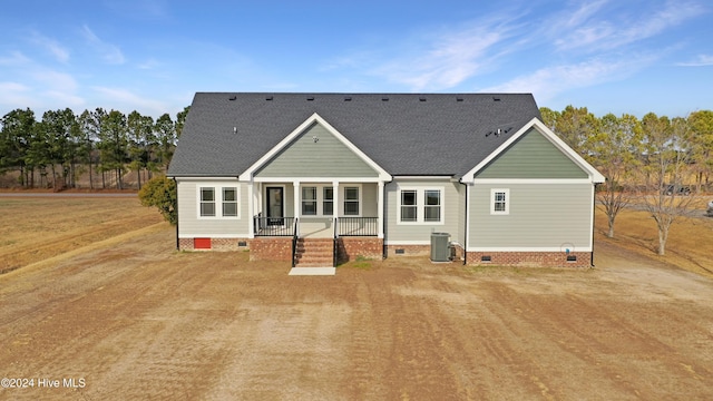 rear view of house featuring central air condition unit and a porch