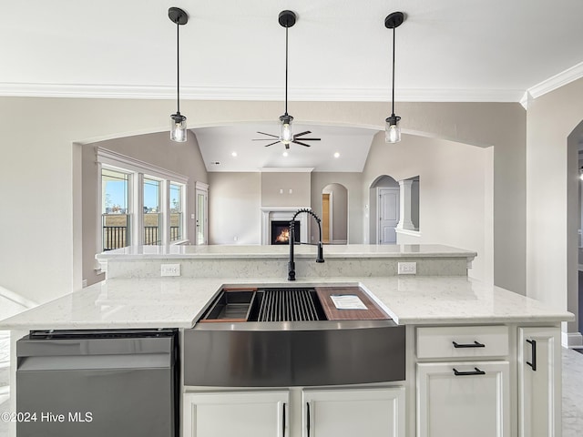 kitchen featuring white cabinetry, sink, light stone counters, decorative light fixtures, and lofted ceiling