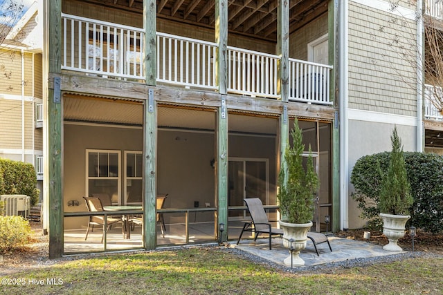 back of house featuring a balcony, a patio, and cooling unit