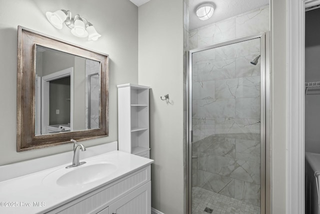 bathroom featuring a shower with door and vanity