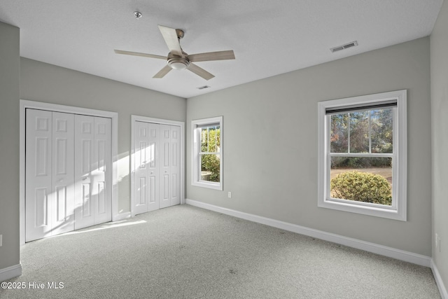 spare room featuring ceiling fan and carpet