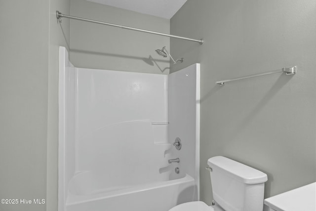 bathroom with toilet and washtub / shower combination