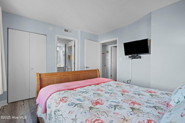 bedroom with wood-type flooring and a closet