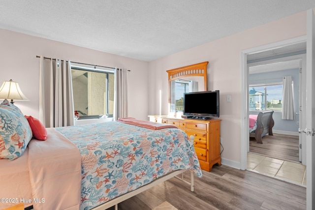 bedroom featuring a textured ceiling and light wood-type flooring