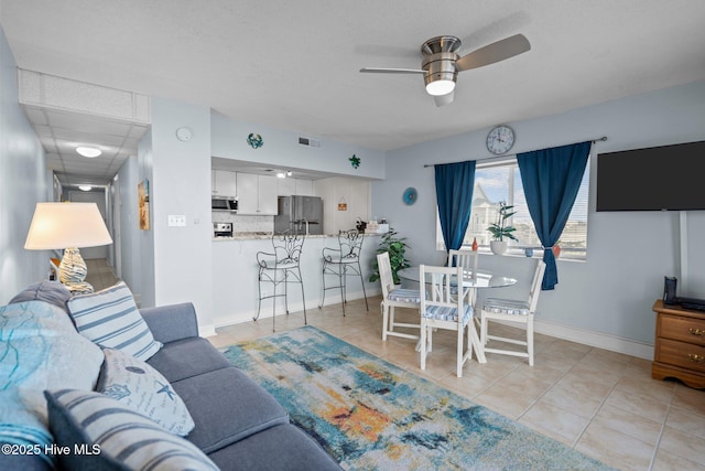 tiled living room with ceiling fan