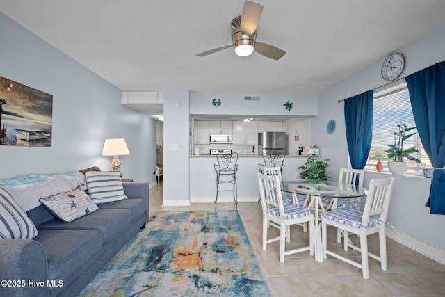 tiled living room featuring ceiling fan